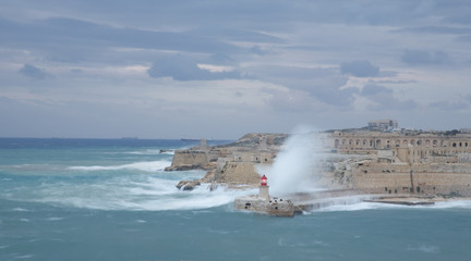 Obraz na płótnie Canvas Lighthouse in the Grand Harbour in Valletta city - capital of Malta. Malta island. Mediterranean sea - Image