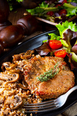 Pork steak with mushrooms and buckwheat groats and mango salad