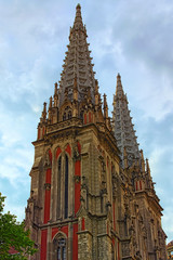 Fototapeta na wymiar Concept of Gothic style in architecture. Stunning decoration of two towers of Saint Nicholas Roman Catholic Cathedral (House of Organ Music) in Kyiv, Ukraine. Spring morning view.