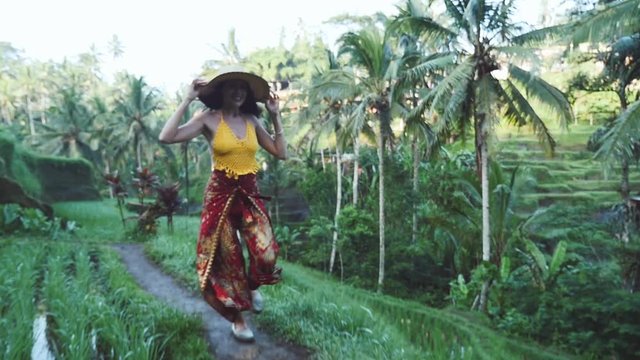 Beautiful girl spending day at the rice terrace in Bali