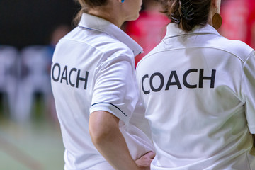 Female coaches in white COACH shirt