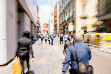 Busy city people going along the street. Intentional motion blur