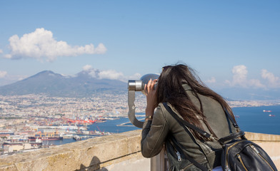 Woman looking at coin operated binocular