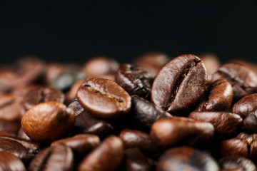 Roasted coffee beans on dark background. Close up