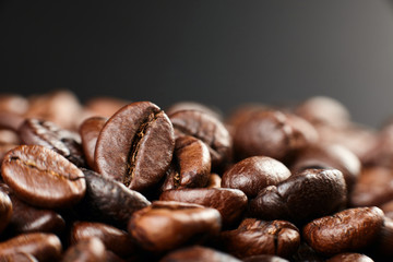 Roasted coffee beans on dark background. Close up