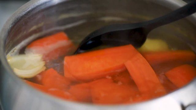 Vegetable stock boiling in a pot, closeup view. Healthy cooking concept