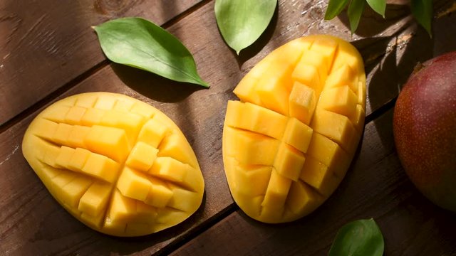 Tasty mango on wooden table, top view. Healthy exotic fruit, vegetarian food