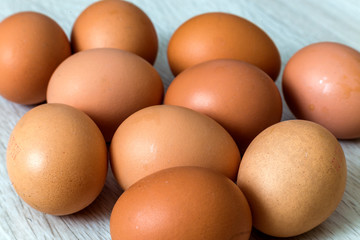 Hen eggs on kitchen table background. Healthy organic food, delicious meal, cholesterol and diet concept.