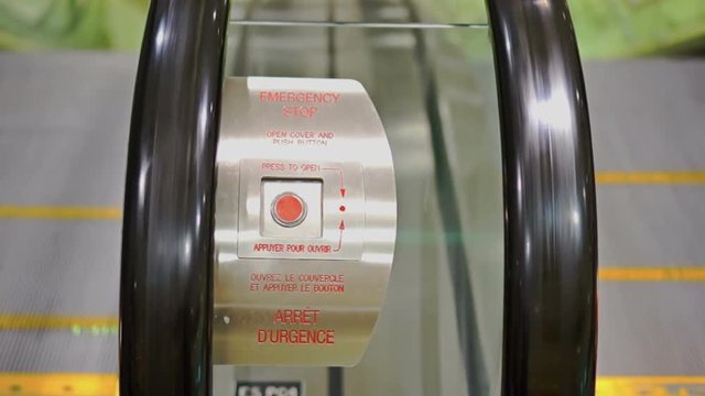 Emergency stop button on escalator. A safety feature of modern escalators, this button stops the moving escalators in case of emergency.