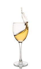 White wine is poured into a wine glass on a white background.