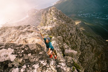 A climber scaling a steep rocky ridge on Table Mountain above Cape Town South Africa - 267217143