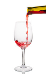 Red wine pouring into wine glass isolated on white background.
