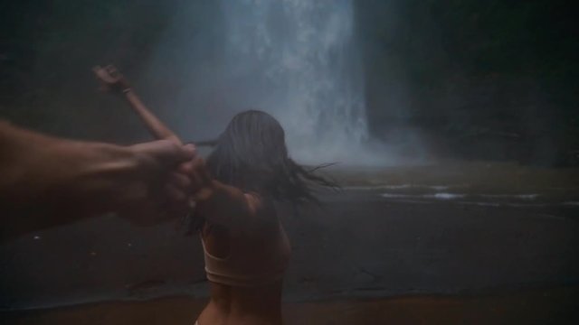 Beautiful girl having fun at the waterfalls in Bali. Concept about wanderlust traveling and wilderness culture