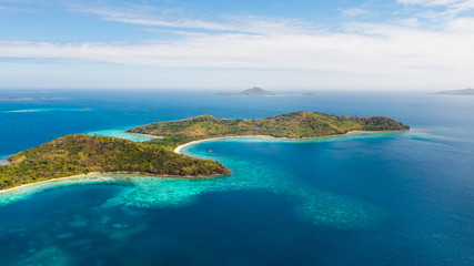 Aerial view tropical beach on island Ditaytayan. tropical island with white sand bar, palm trees and green hills. Travel tropical concept. Palawan, Philippines