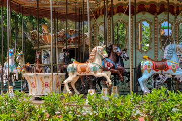 Fototapeta na wymiar Carousel with horses in an amusement park