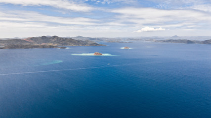 aerial view tropical islands with blue lagoon, coral reef and sandy beach. Palawan, Philippines. Islands of the Malayan archipelago with turquoise lagoons.
