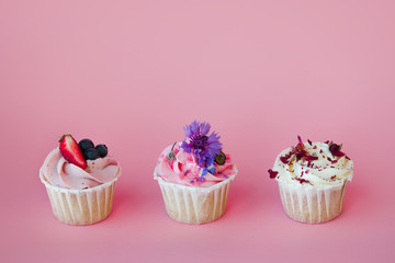 set of delicious cupcakes with different fillings and cream. Three muffin's with cream