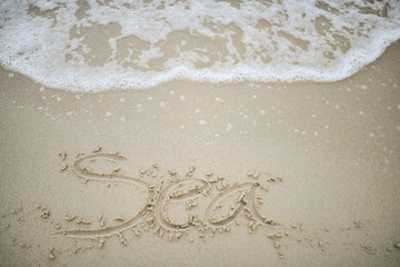 Sea text on the beach for the background.