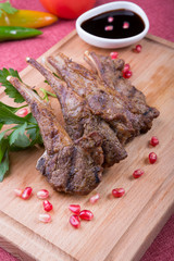 Roasted lamb meat chops served with po,egranate