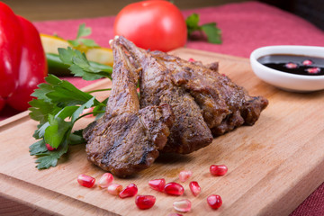 Roasted lamb meat chops served with po,egranate