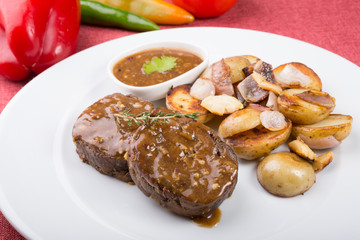 Meat cutlets served with fried potatoes
