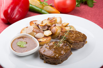 Meat cutlets served with fried potatoes
