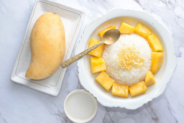 Mango sticky rice is a traditional Thai dessert made with glutinous rice, fresh mango and coconut milk, and eaten with a fork, spoon, or sometimes the hands.