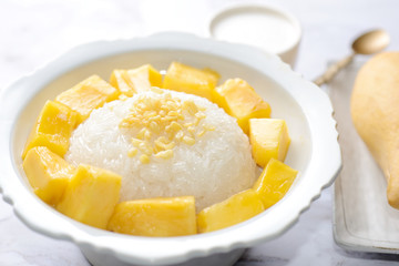 Mango sticky rice is a traditional Thai dessert made with glutinous rice, fresh mango and coconut milk, and eaten with a fork, spoon, or sometimes the hands.