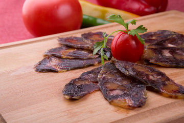 Rustic raw smoked meat sliced on chopping board