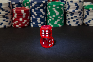 Two red dice on the background of the poker game