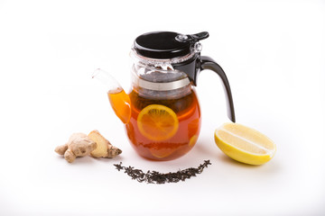 Glass transparent teapot on white backgrounf with tea ingredients