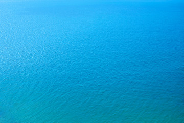 Texture of blue sea, seen from above, flat lay.