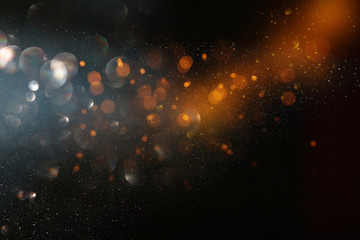 abstract glitter lights background. black and gold. de-focused
