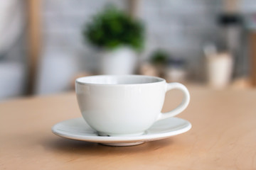 A white cup on wooden table