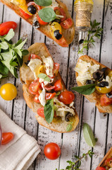 Fototapeta na wymiar Crostini with tomatoes and olives