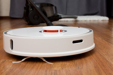 Comparing an old vacuum cleaner with an automated smart cleaning robot