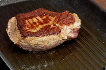 Cooking delicious, juicy steak at home. Fry meat in a grill pan