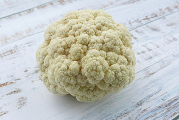 Top view of cauliflower on wooden background.