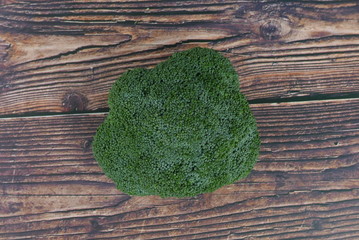 Top view of broccoli on wooden background. 