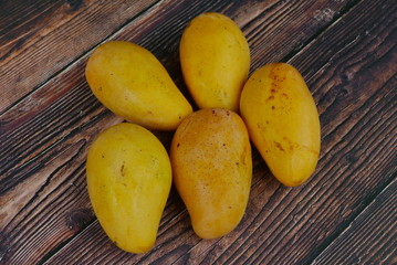 Top view of Chok Anan or Chocanon mango on wooden background.
