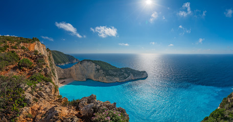 Panoramic view of the sun shining over cliffs in Shipwreck Cove