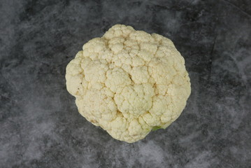 Top view of cauliflower on grey,black and white floor.