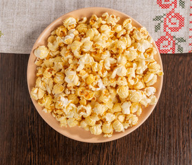 A plate of popcorn and a napkin on the table.