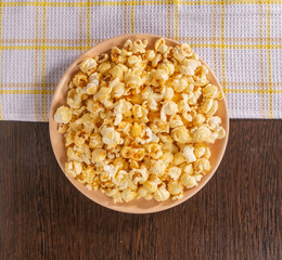 A plate of popcorn and a napkin on the table.