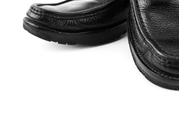 Black leather shoes isolated on white background with copy space.