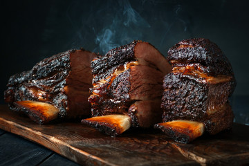 A large steaming fragrant piece of baked beef brisket on the ribs with a dark crust. Classic Texas...
