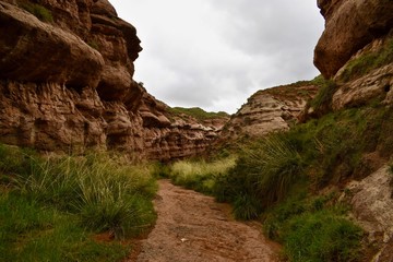 Narrow walking path between sandstones in Pingshan Grand Canyon National Park in Gansu province, China