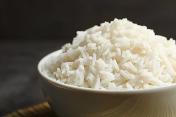Bowl of tasty cooked white rice on table, closeup