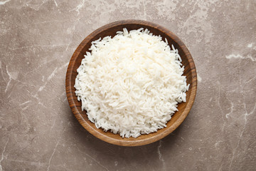 Fototapeta na wymiar Plate of tasty cooked rice on color background, top view