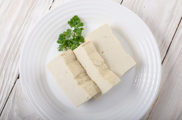 Soy Bean curd tofu on clay dish closeup. Non-dairy alternative substitute for cheese